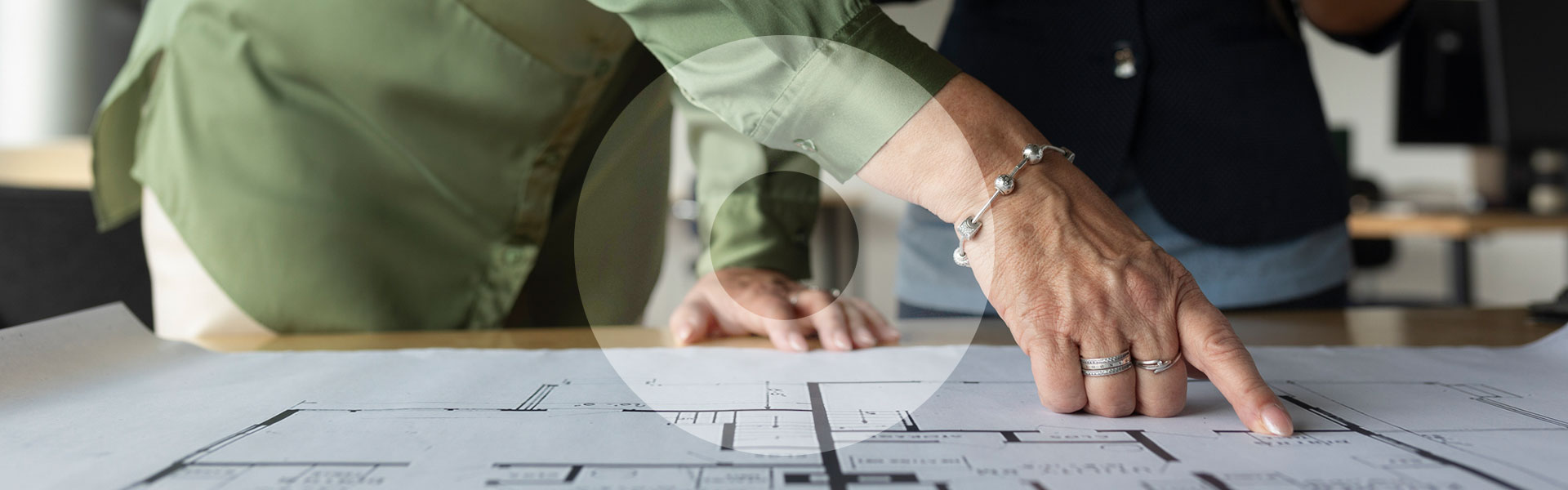 Architect pointing at house plans