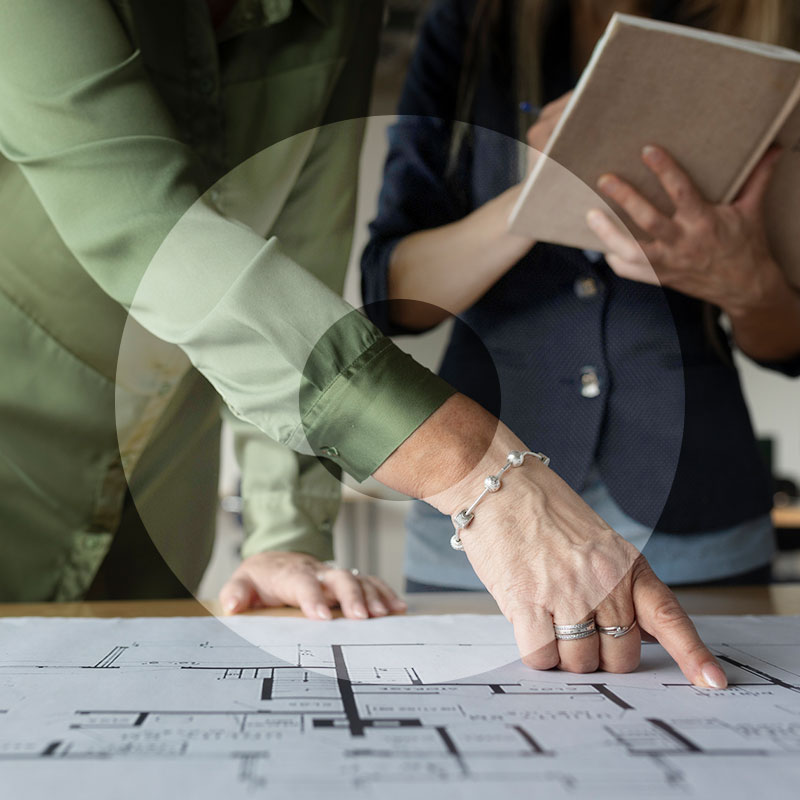 Architect pointing at house plans