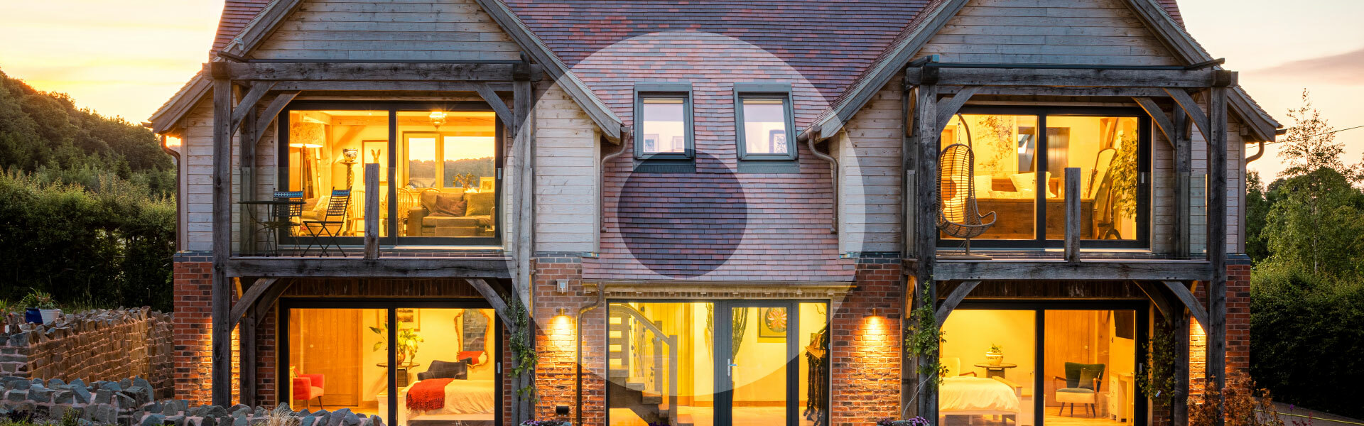 External image of a house with 21 Degrees windows, the lights on at dusk