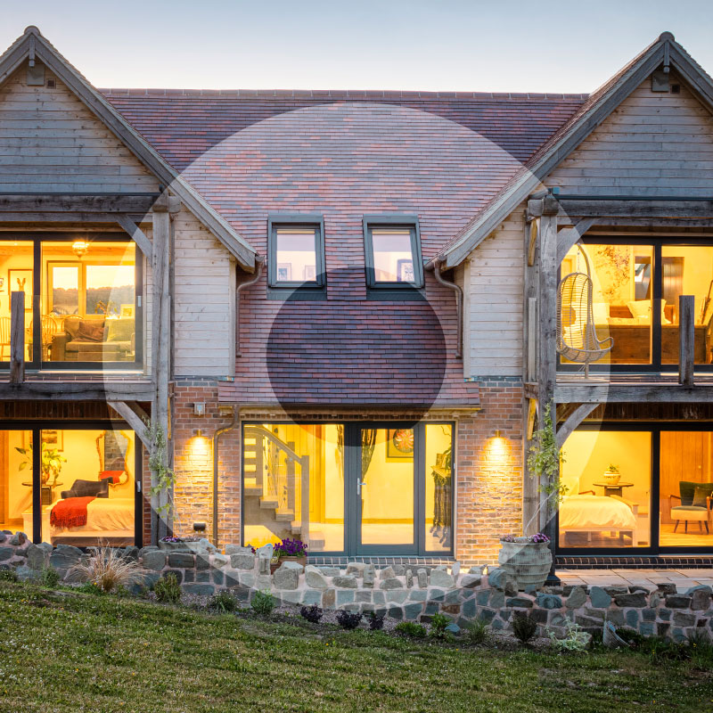External image of a house with 21 Degrees windows, the lights on at dusk
