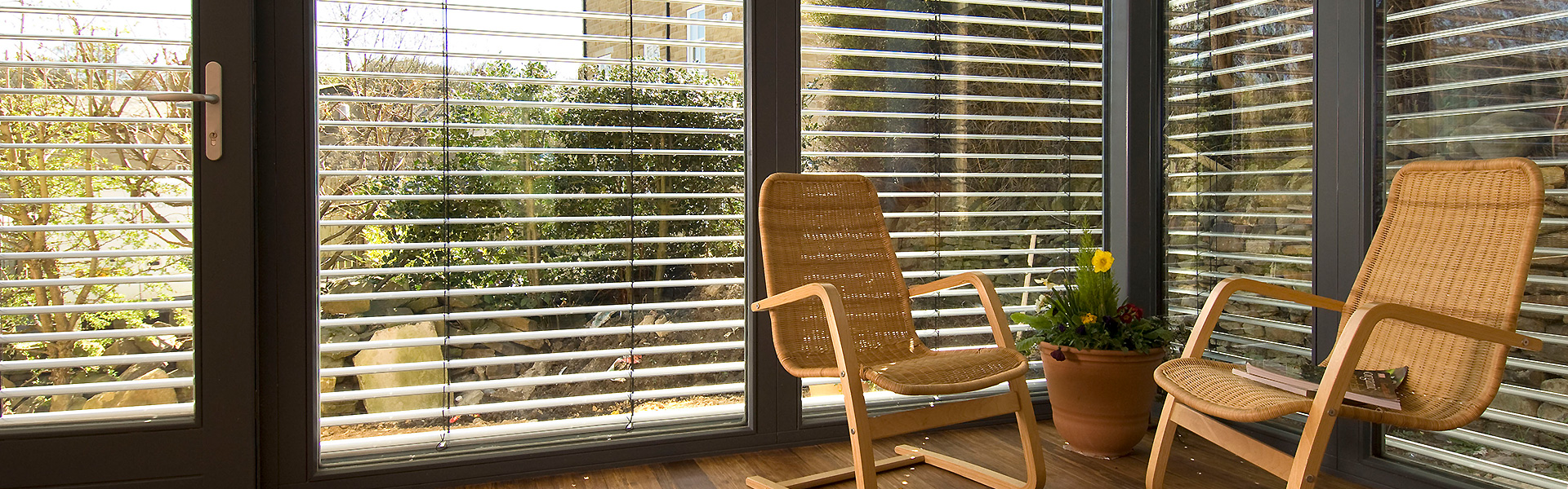 Indoor sun room with 21 Degrees windows and two chairs