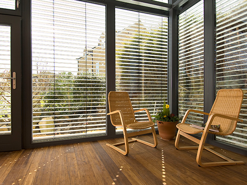 Indoor sun room with 21 Degrees windows and two chairs